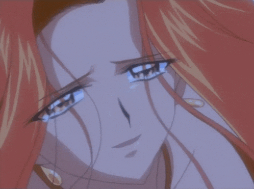 a close up of a woman with red hair crying