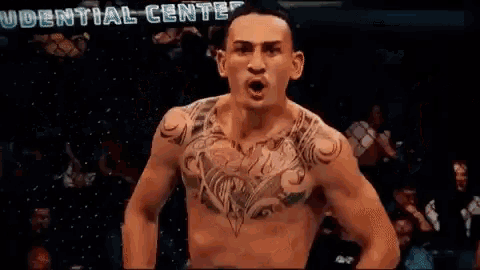 a shirtless fighter with a tattoo on his chest