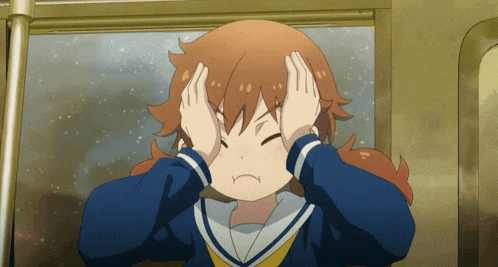 a girl covering her ears with her hands and making a funny face