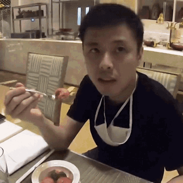 a man wearing a face mask is eating food from a plate