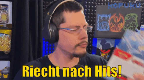 a man wearing headphones and glasses is holding a package that says " richt nach hits "