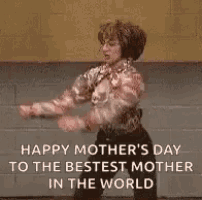 a woman is dancing in front of a brick wall .