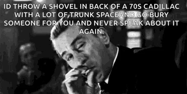 a man in a suit and tie is holding a shovel in his hand .