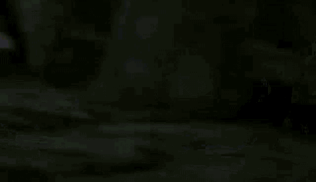 a purple robot with a sword and shield is walking in the dark