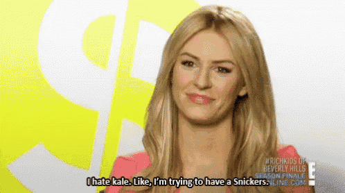 a woman in a pink shirt says i hate kale like i 'm trying to have a snickers