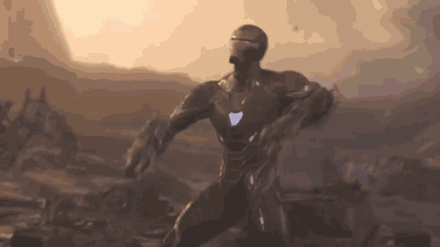 a man in a superhero costume is standing in a field .