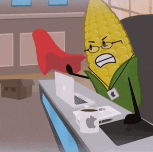 a cartoon of corn on the cob sitting at a desk