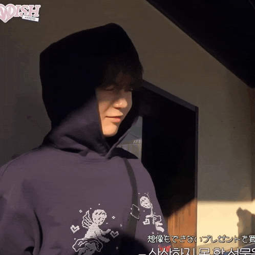 a man wearing a black hoodie with wish written on it