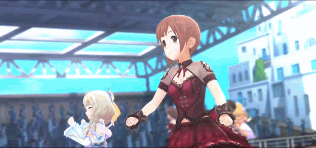 a girl in a red dress is dancing with another girl