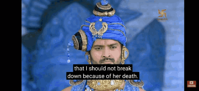 a man is wearing a blue turban and necklace and says that i should not break down because of her death .