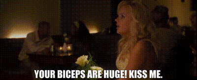 a woman sitting at a table with the words your biceps are huge kiss me on the bottom