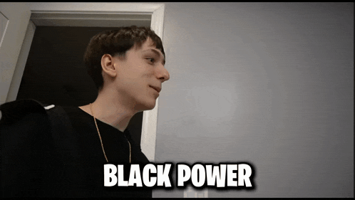 a man in a black shirt is standing in a doorway with the words " black power " written above him