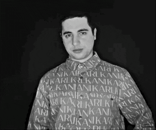 a black and white photo of a man wearing a shirt that says karl karl kanik