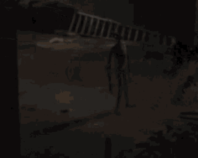a silhouette of a person is walking in the dark