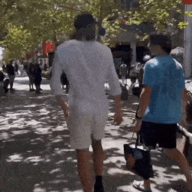 a man in a blue shirt that says ' hawaii ' on it