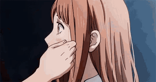 a close up of a person touching a girl 's face with their hand .