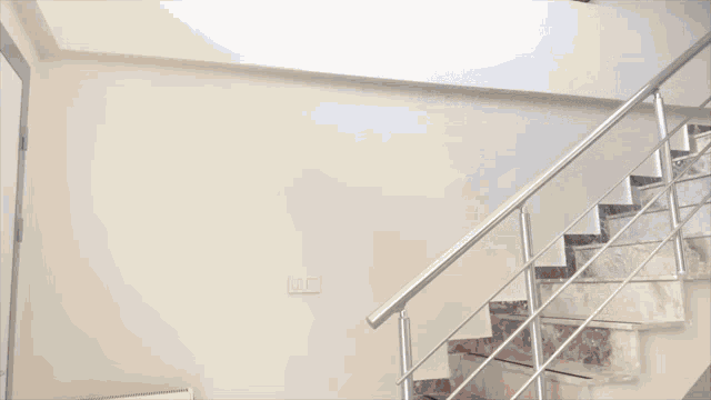 a man in a suit is walking down stairs