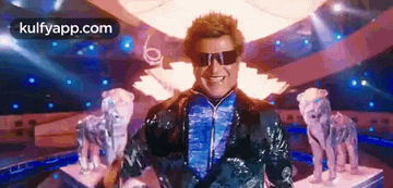 a man wearing sunglasses is standing in front of a statue of a dog and a statue of a tiger .