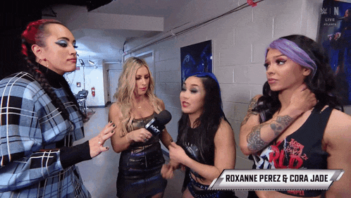 roxanne perez and cora jade are standing next to each other in a hallway