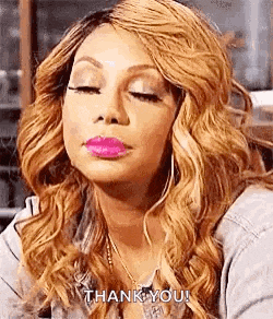 a woman with blonde hair and pink lipstick is making a funny face .
