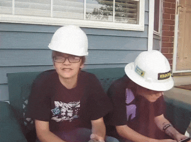 two boys wearing hard hats one of which has the word krakow on it