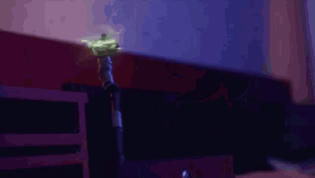 a cane is glowing in the dark in a room .