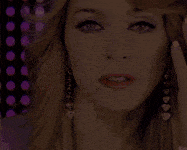 a close up of a woman 's face wearing earrings