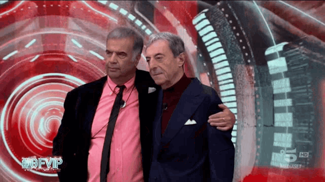 two men standing next to each other in front of a screen that says ' hd ' on it
