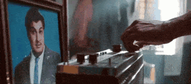 a picture of a man in a suit and tie is next to a radio .
