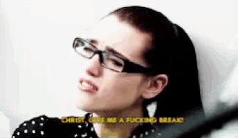 a woman wearing glasses says christ give me a fucking break .