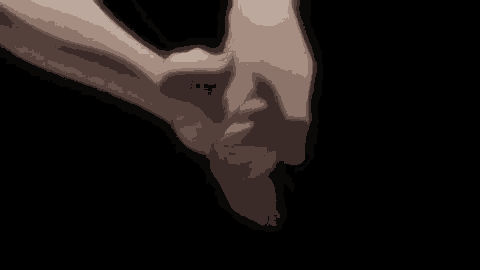 a close up of a person holding another person 's hand .