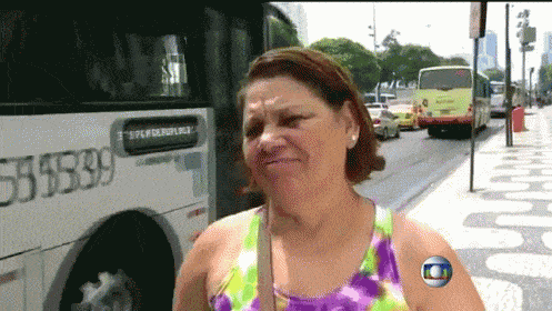 a woman is standing in front of a bus with the number 55139 on it