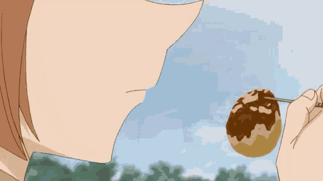 a person is eating a ball of food with a spoon
