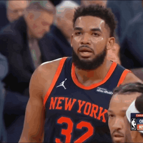 a basketball player for the new york knicks looks at the camera