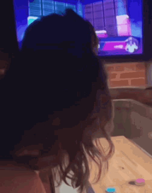 a person playing a video game with a purple screen