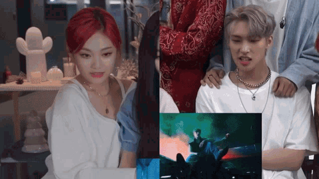 a girl with red hair is sitting next to a man