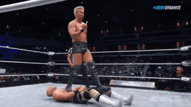 a wrestler in a ring with the word dynamite on the bottom