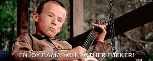a young boy is sitting on a porch swing playing a guitar and says enjoy bama you mother fucker