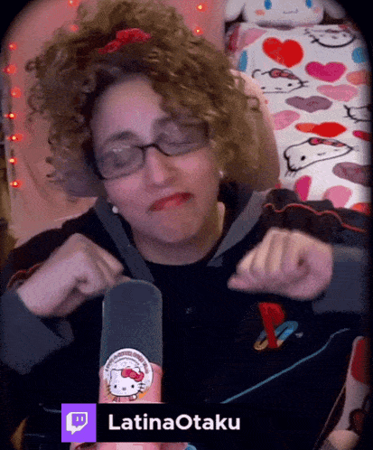 a woman with curly hair is wearing glasses and a hello kitty sticker on her hand