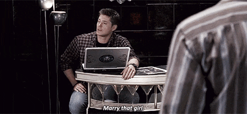 a man is sitting at a table with a laptop on it .
