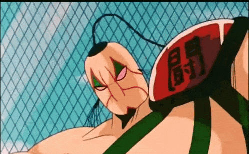 a cartoon character is standing in front of a chain link fence with chinese writing on his back .