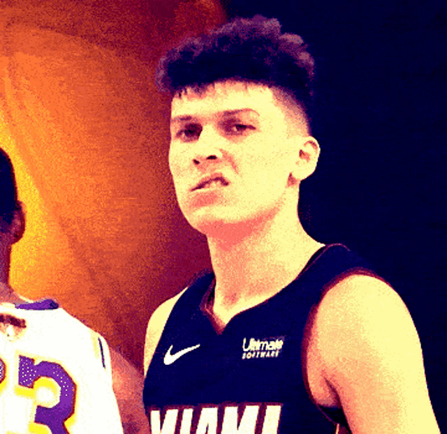 a man wearing a miami jersey looks to his left