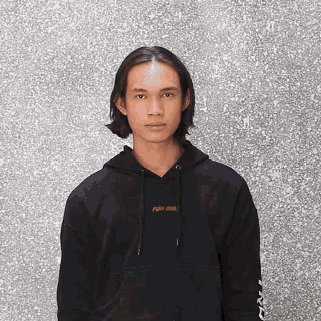 a man wearing a black hoodie with the word fun on it