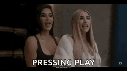 two women are standing next to each other and one of them is screaming .