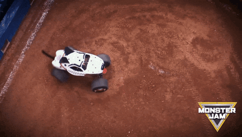 a monster jam advertisement with a white monster truck in the dirt