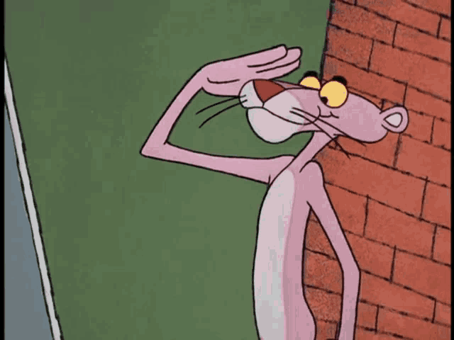 a pink panther is standing next to a brick wall and covering his eyes