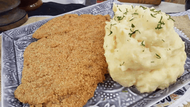 a plate of food with mashed potatoes and chicken