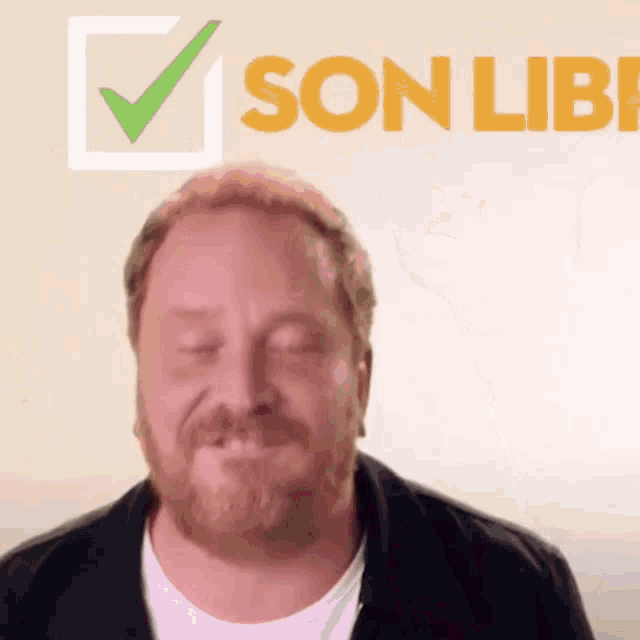 a man with a beard is smiling in front of the word son