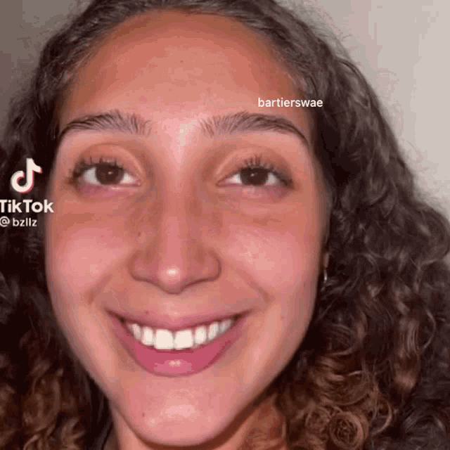 a close up of a woman 's face with tiktok written on the bottom