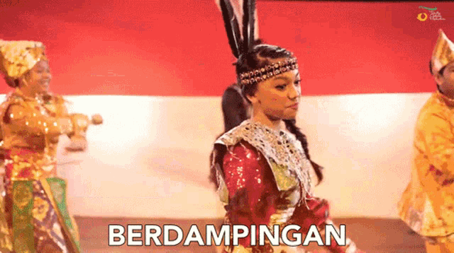 a group of people are dancing and the word berdampingan is visible